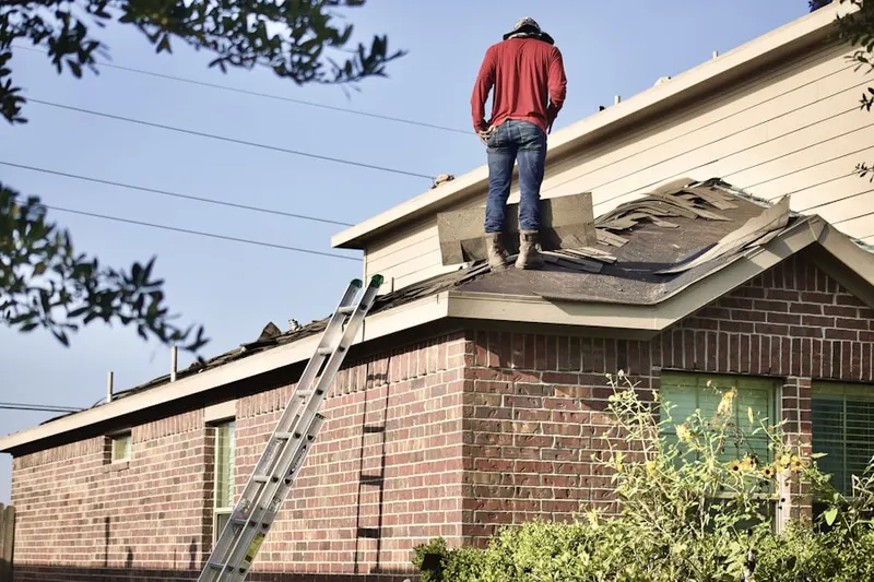 Professional roofer working on a residential roof in Rhinebeck